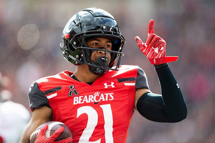 Cincinnati Bearcats wide receiver Tyler Scott (21) celebrates after scoring a touchdown during the first quarter of the NCAA football game between the Cincinnati Bearcats and the Indiana Hoosiers at Nippert Stadium, Saturday, Sept. 24, 2022. Indiana Hoosiers At Cincinnati Bearcats Ncaa Football Sept 24